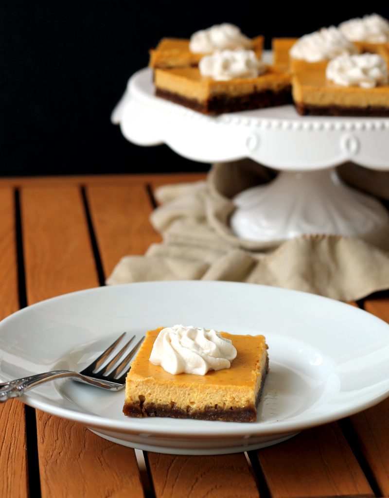 These Gingersnap Pumpkin Cheesecake Bars have a crunchy gingersnap cookie crust topped with a luscious, smooth pumpkin cheesecake filling. You'll love these spiced bars!