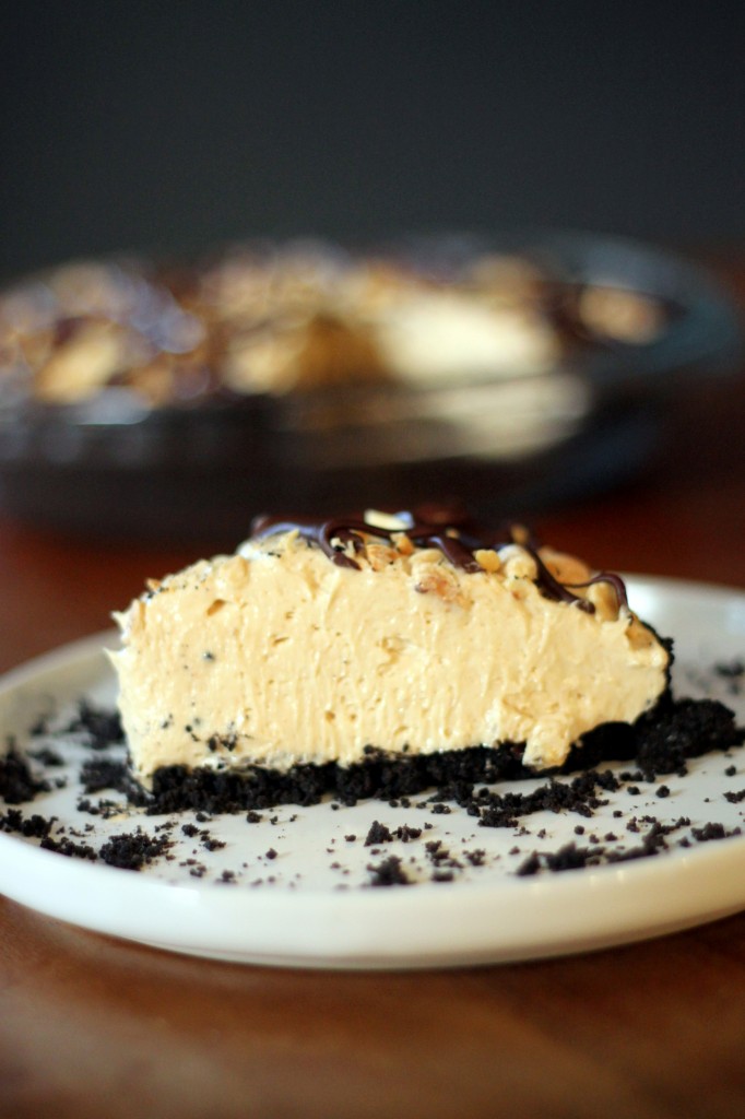 This Chocolate Peanut Butter Mousse Pie has an Oreo crust, a creamy peanut butter mousse, and a drizzle of chocolate and peanuts! No baking required for this easy recipe.