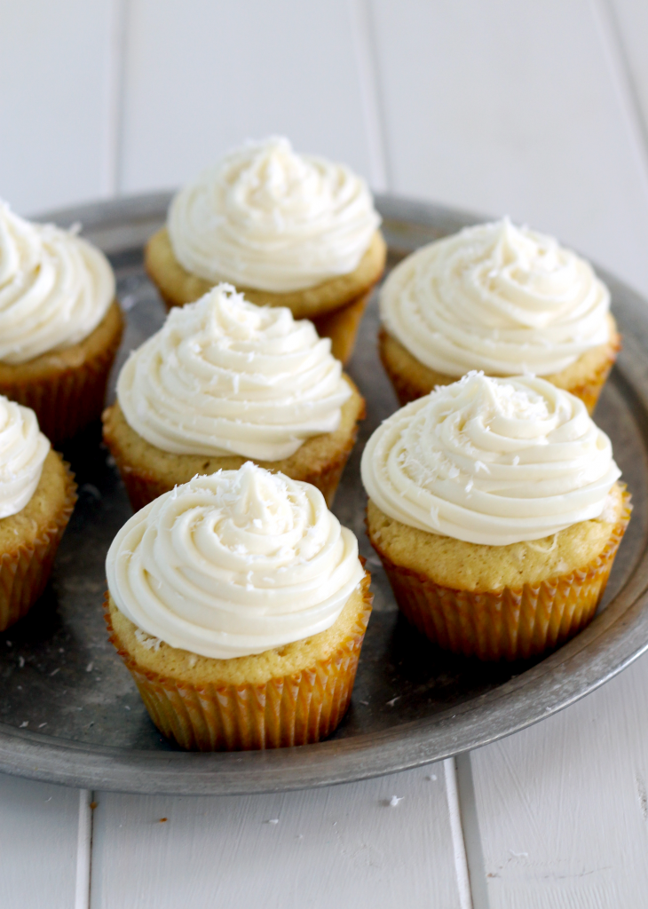 These soft and sweet Coconut Cupcakes have a coconut truffle stuffed in the middle, and are topped with an tangy, creamy white chocolate cream cheese frosting! This irresistible treat with be a favorite of any coconut lover.