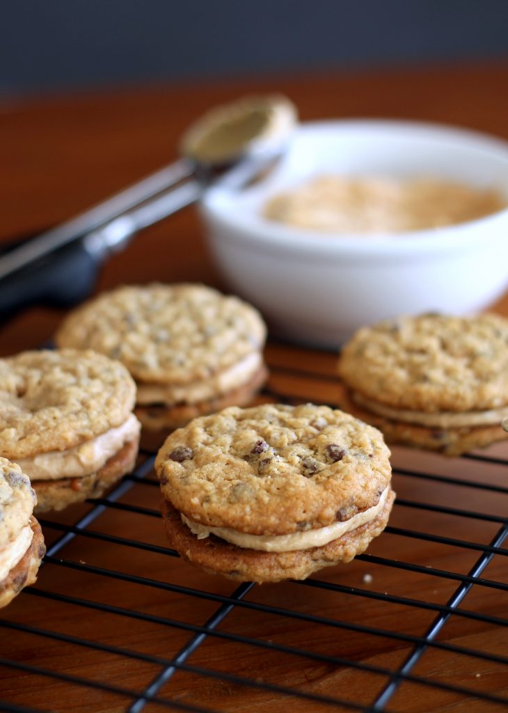 These Peanut Butter Oatmeal Chocolate Chip Cookie Sandwiches are chewy oatmeal cookies sandwiched with a creamy peanut butter frosting. 