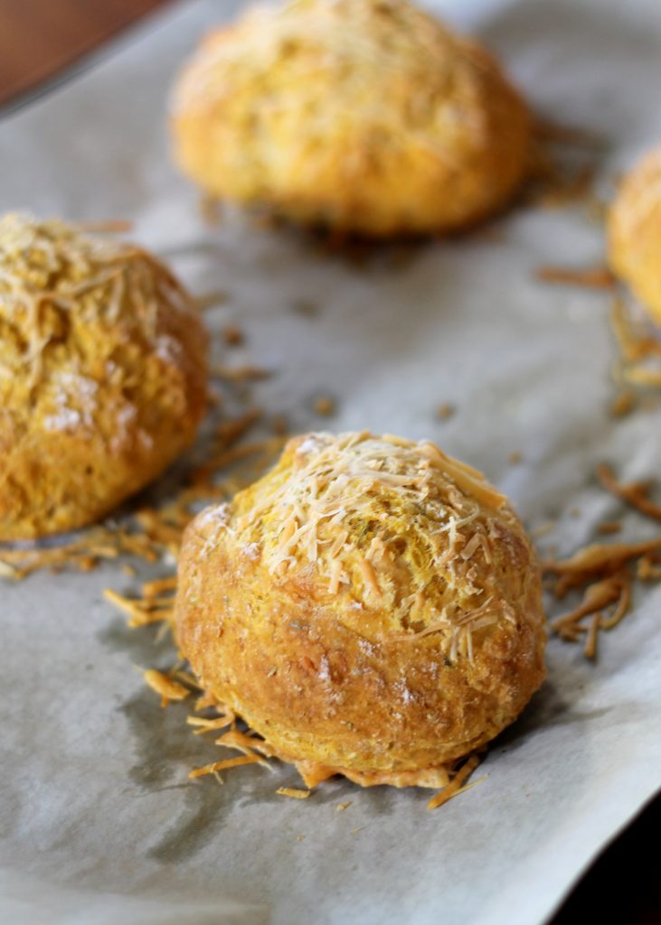These easy, no-yeast Pumpkin Parmesan Bread Rolls are filled with herbs and topped with cheese. These are the perfect soup companion!