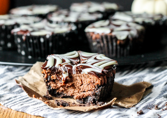 These Death by Chocolate Mini Cheesecakes have an Oreo cookie crust, a creamy chocolate cheesecake studded with chocolate chips, all topped with a chocolate ganache spiderweb.