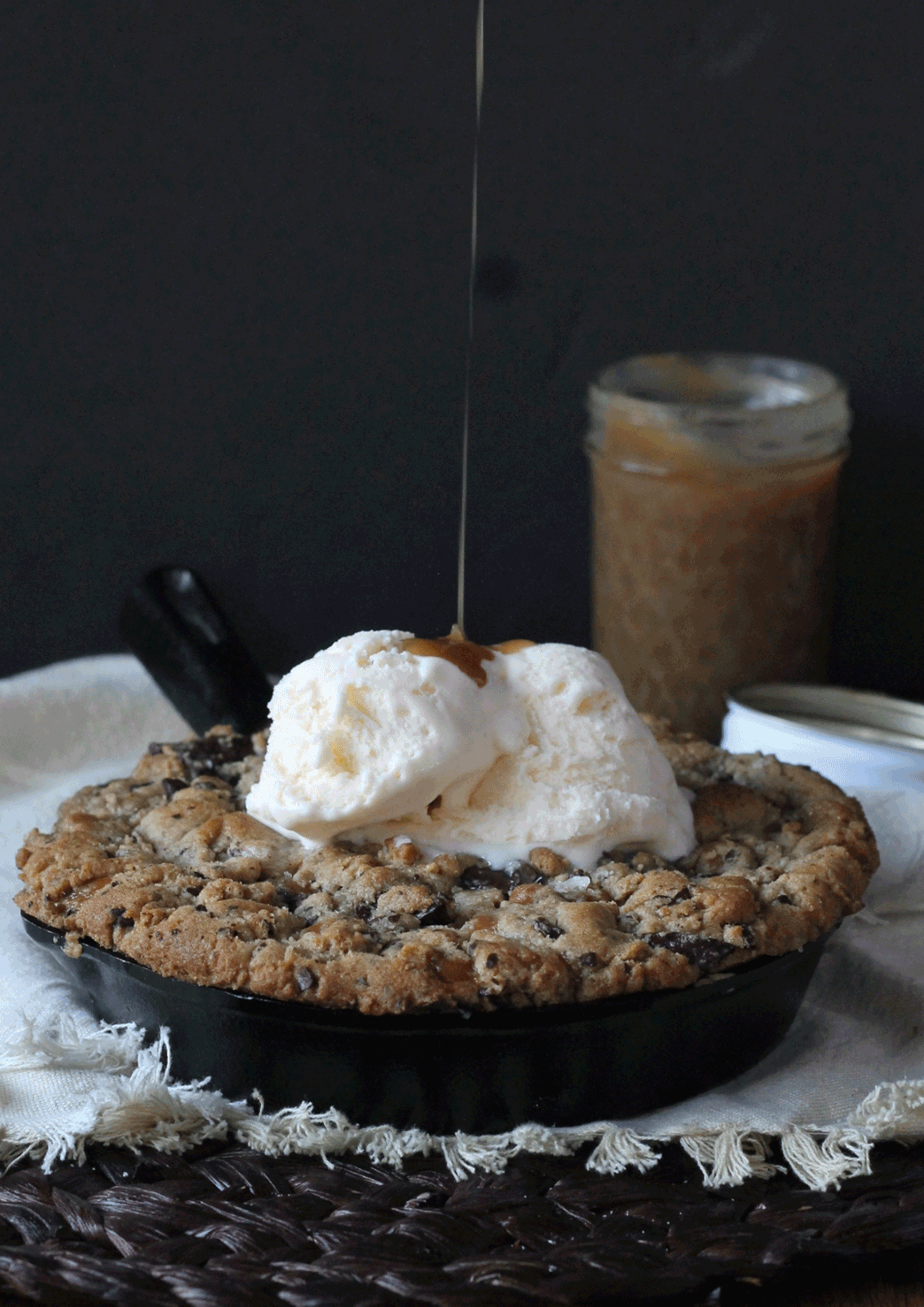 This Salted Caramel Filled Dark Chocolate Chunk Skillet Cookie is gooey, crunchy, and flowing with salted caramel! This is one treat best served with ice cream and friends.