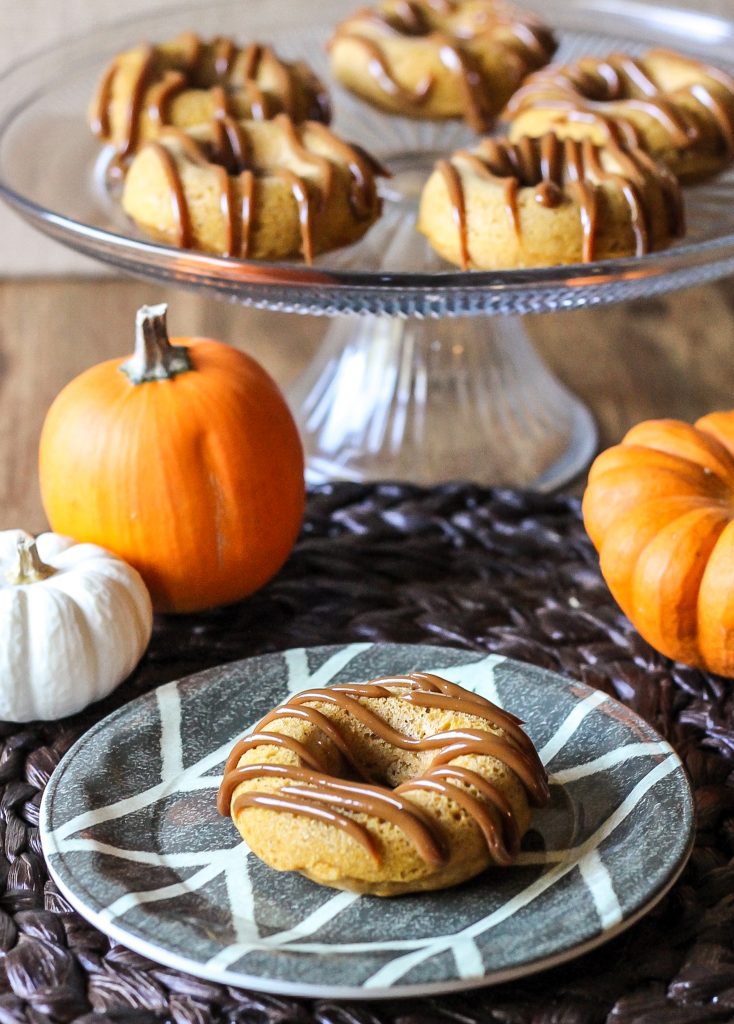 These Pumpkin Dulce De Leche Baked Doughnuts are filled and drizzled with dulce de leche for a sweet treat that's sure to satisfy!