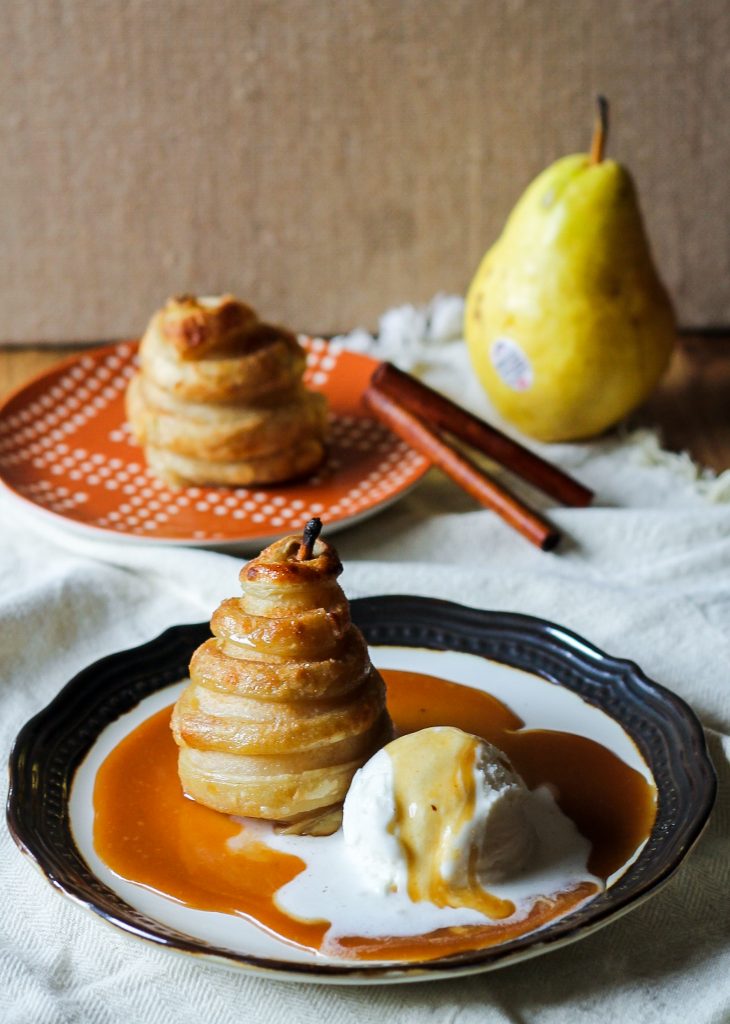 These Apple Cider Poached Pears in Cinnamon Sugar Puff Pastry are easier than you'd think, and use poaching liquid to make a caramel sauce!