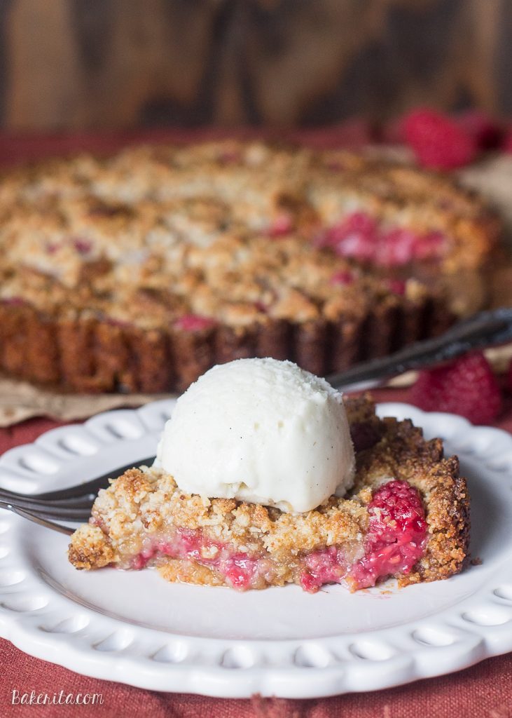 This Raspberry Coconut Crumble Tart has an almond coconut crust that doubles as a crumble topping, filled with fresh raspberries! This easy recipe is Paleo-friendly, gluten free, refined sugar free, and vegan.