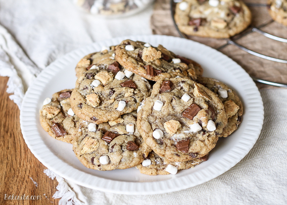 Skip the campfire and whip up a batch of S'mores Cookies! Made with graham cracker cookie dough, chocolate chips & marshmallow bits, these s'mores cookies taste just like your favorite summer treat so you can have s'mores year round.