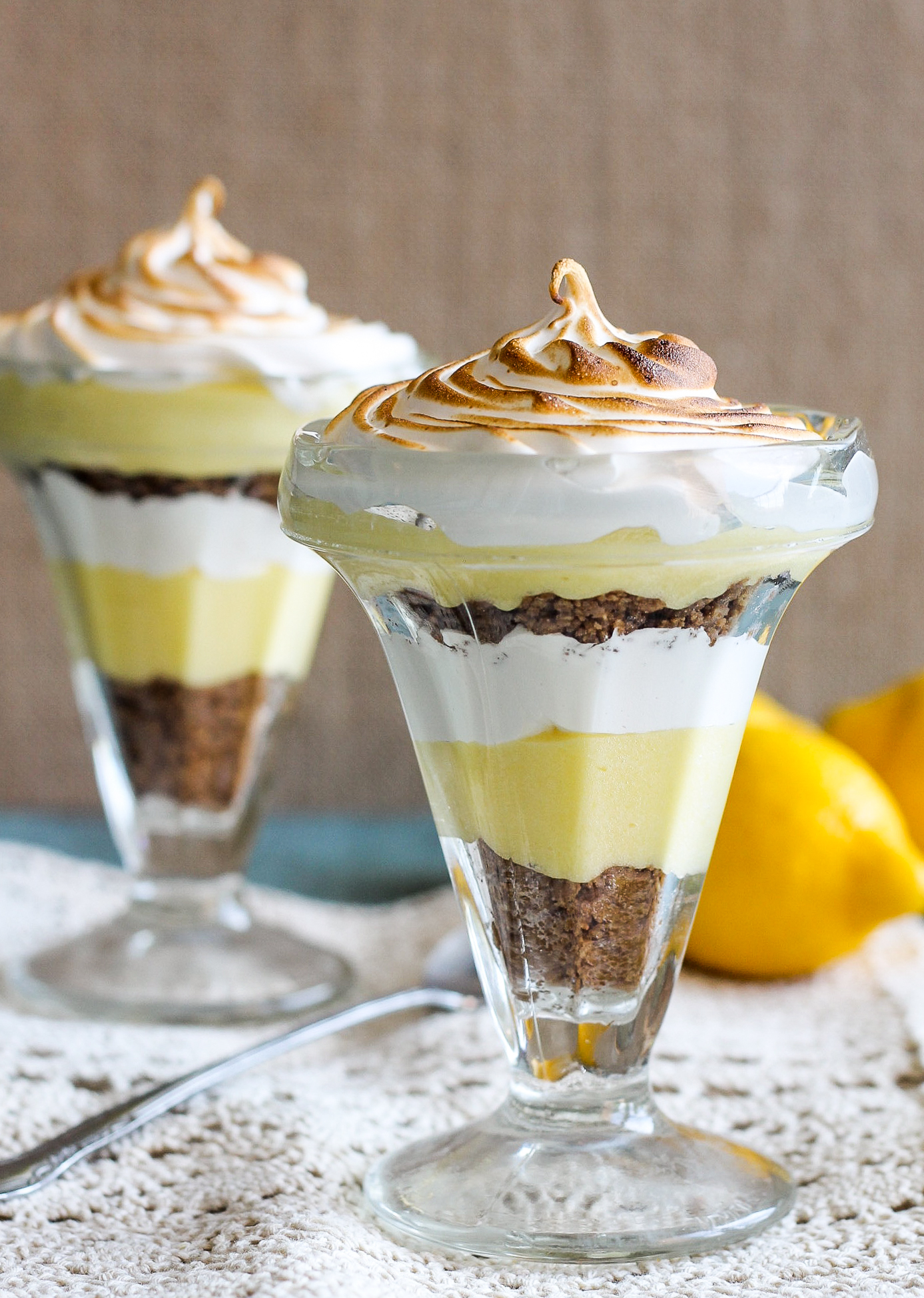 These Lemon Meringue Pie Parfaits are a no-bake dessert that will be your new summer favorite! Lemon curd, graham cracker crumbs, and meringue makes the best individual treats.