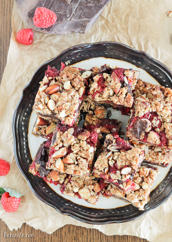 These Raspberry Chocolate Chunk Bars have a crust that doubles as a crumble topping and are loaded with raspberries, dark chocolate, and almonds. This easy recipe is gluten free, refined sugar free, and vegan!
