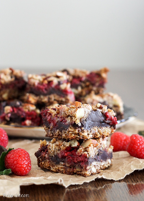 These Raspberry Chocolate Chunk Bars have a crust that doubles as a crumble topping and are loaded with raspberries, dark chocolate, and almonds. This easy recipe is gluten free, refined sugar free, and vegan!