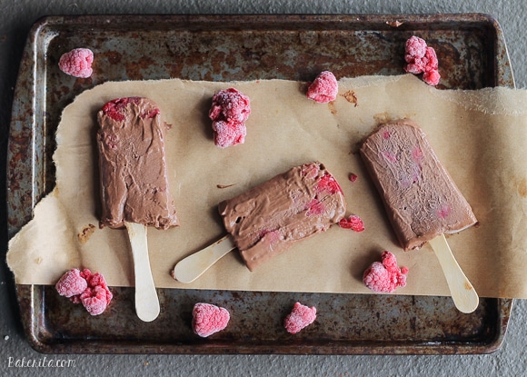These Chocolate Raspberry Popsicles are a refreshing frozen chocolate treat to enjoy on a hot day. These pops, filled with raspberries, are also vegan!