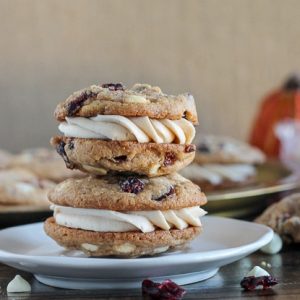 Pumpkin Spice Cookie Sandwiches with Cream Cheese Filling are easy and delicious! The pumpkin spice cookies are made even better with white chocolate and dried cranberries.