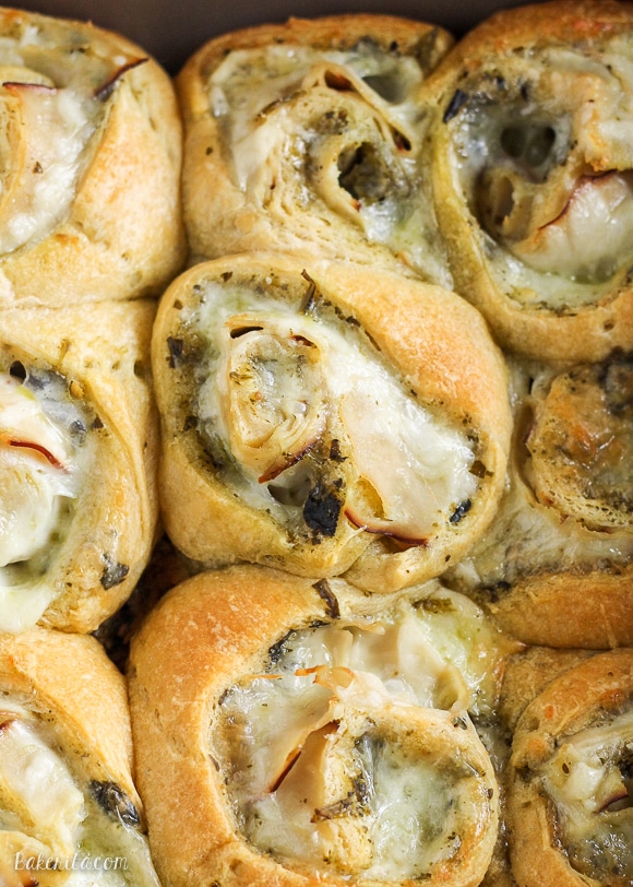These Cheesy Turkey Pesto Rolls make a great snack or appetizer perfect for tailgating or the holidays! Gooey mozzarella makes this easy four ingredient recipe absolutely irresistible.