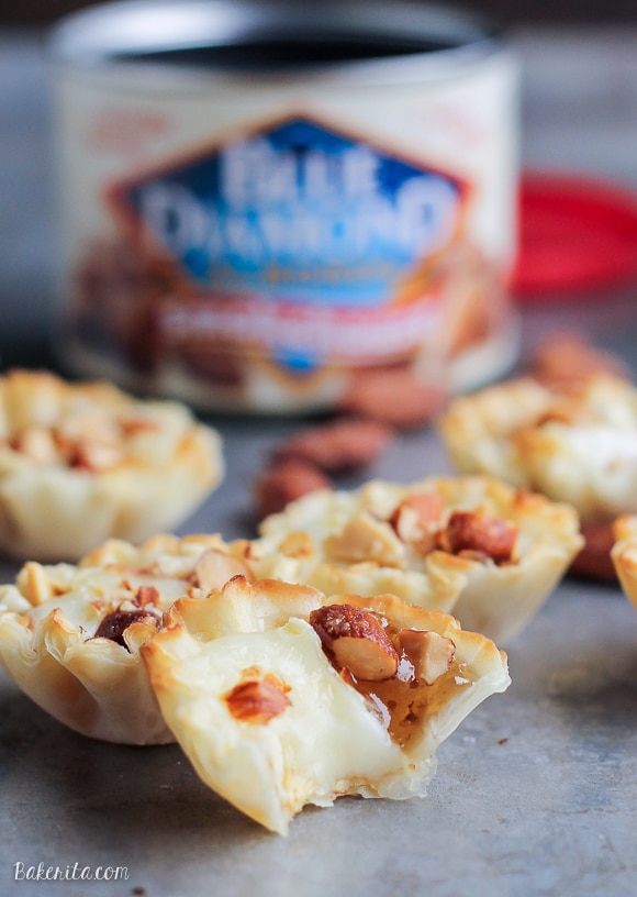 These Easy Brie Bites have only four ingredients, but make a delicious appetizer that you won't be able to get enough of! Gooey brie and crunchy smokehouse almonds make this simple appetizer recipe shine. 