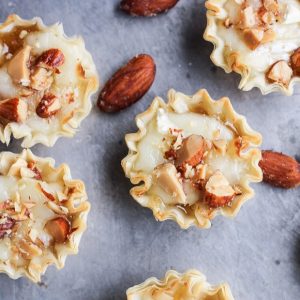 These Easy Brie Bites have only four ingredients, but make a delicious appetizer that you won't be able to get enough of! Gooey brie and crunchy smokehouse almonds make this simple appetizer recipe shine.