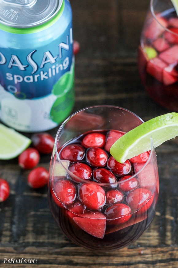This Cranberry Lime Sangria is a sparkling + festive take on sangria! This is the perfect refreshing cocktail for a crowd.