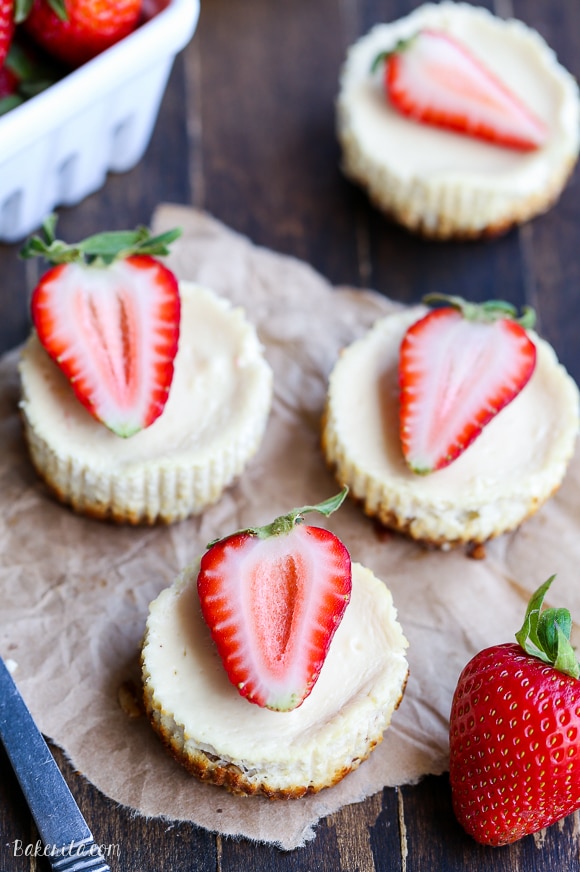 These Greek Yogurt Cheesecakes are smooth and creamy with a bit of tanginess and a crunchy granola crust. These gluten-free cheesecakes were delicious for breakfast topped with fresh berries, and they're only 177 calories each!