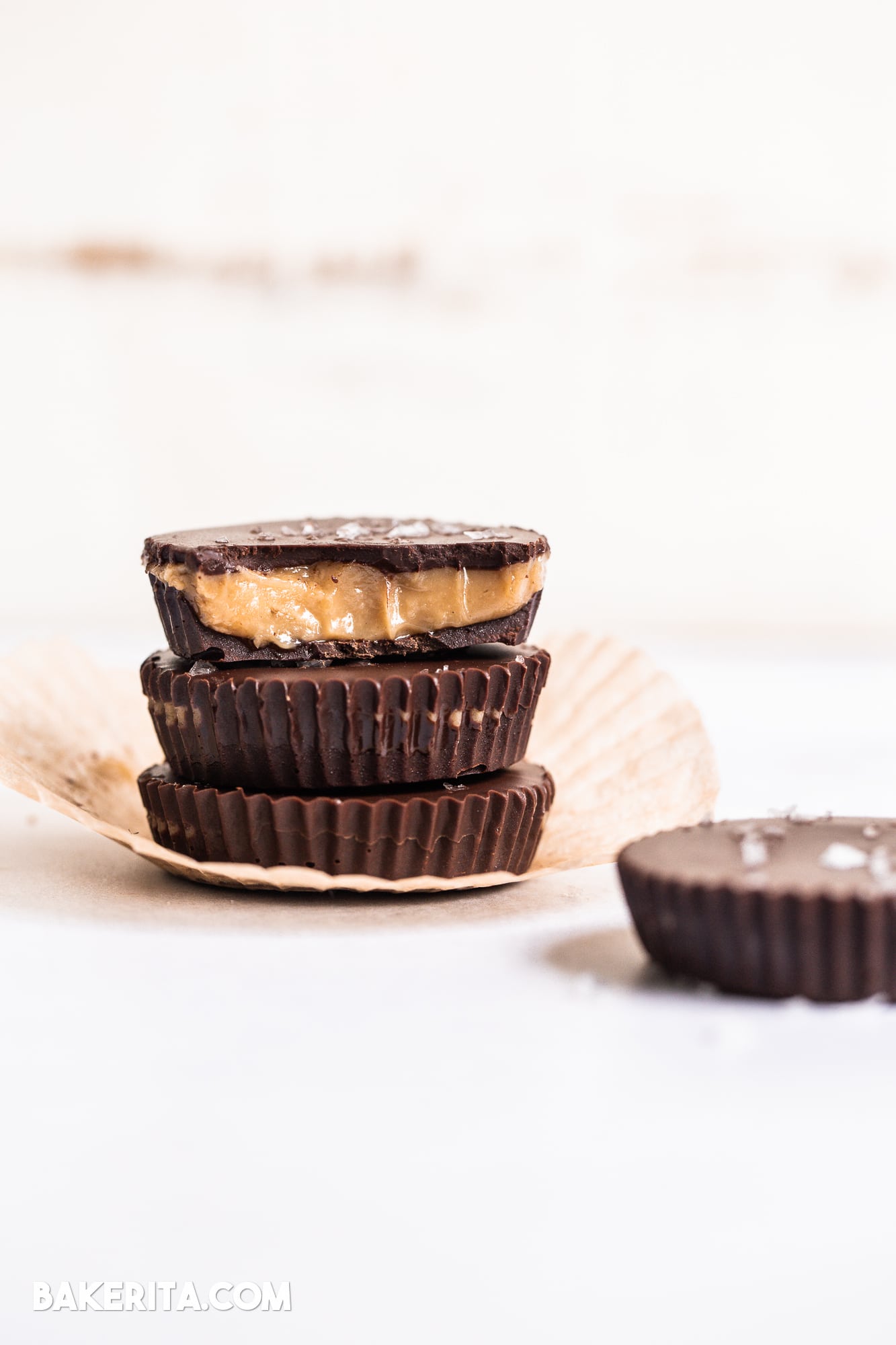 These Vegan Chocolate Peanut Butter Caramel Cups are made with homemade chocolate surrounding a gooey vegan peanut butter caramel. The six-ingredient recipe for these refined sugar-free treats is the perfect way to get your candy fix!