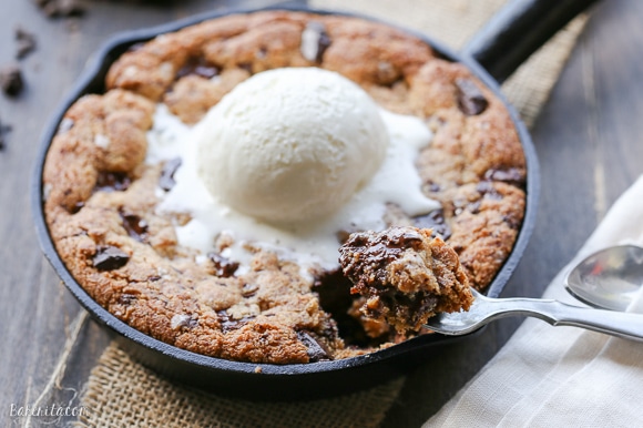 This Paleo Chocolate Chip Skillet Cookie is the ultimate gooey dessert! This gluten free and refined sugar free skillet cookie is a healthier alternative to the classic Pizookie. Use big chocolate chunks to make it extra chocolatey!