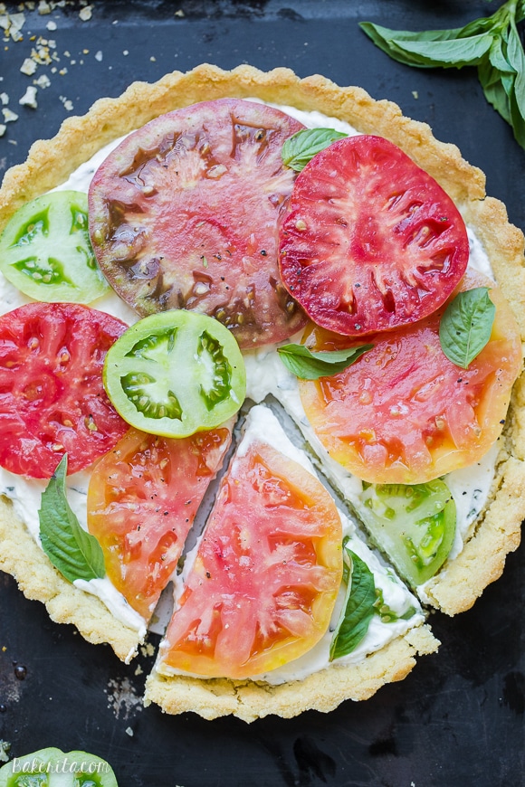 This Ricotta Heirloom Tomato Tart has a gluten-free cornmeal crust and basil ricotta filling, topped with beautiful heirloom tomatoes! This simple tart makes a wonderful appetizer, lunch, or dinner.