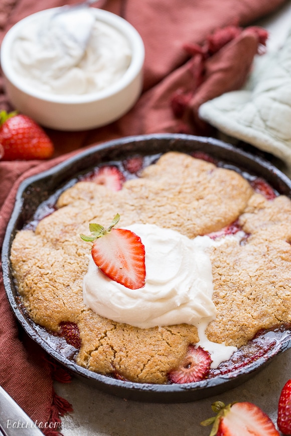 This Strawberry Cobbler recipe makes a small batch that's perfect for sharing between a few people. This gluten-free, Paleo, and vegan dessert is made even better with some whipped coconut cream!