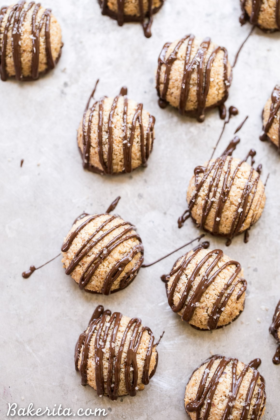 These Chocolate-Dipped Vanilla Bean Macaroons are a quick and easy dessert that is gluten-free, Paleo + vegan! These macaroons are baked low and slow and have a chocolate drizzle.