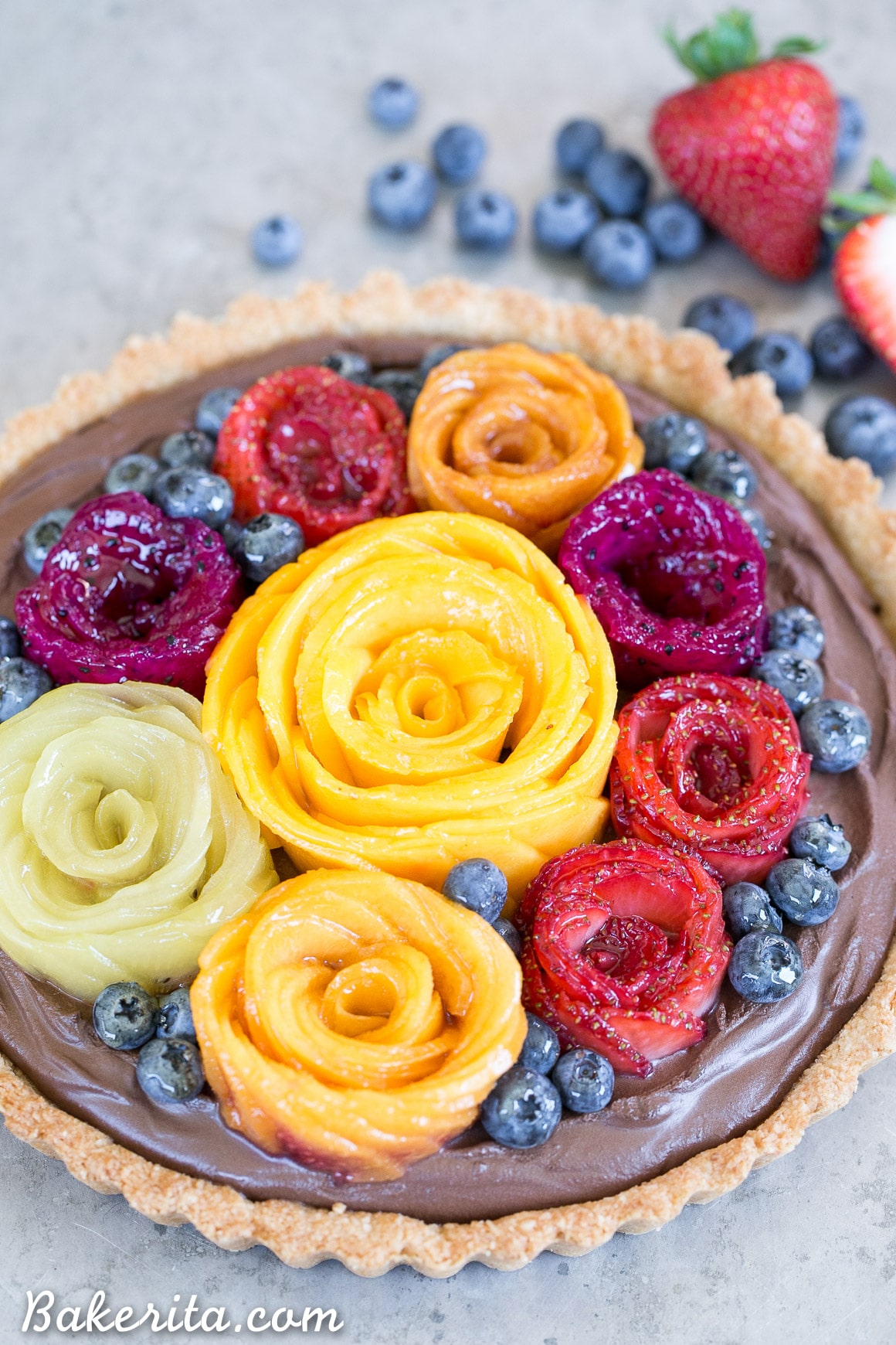 This Chocolate Mousse Tart with Coconut Crust + Fresh Fruit Flowers has the most incredible vegan chocolate mousse filling! You'd never guess that this rich dessert is gluten-free, Paleo, and vegan.