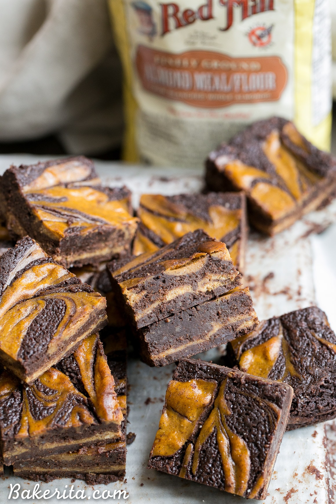 These Pumpkin Cheesecake Brownies are moist + fudgy brownies with a swirled layer of spiced pumpkin cheesecake! These brownies are gluten-free and refined sugar free.