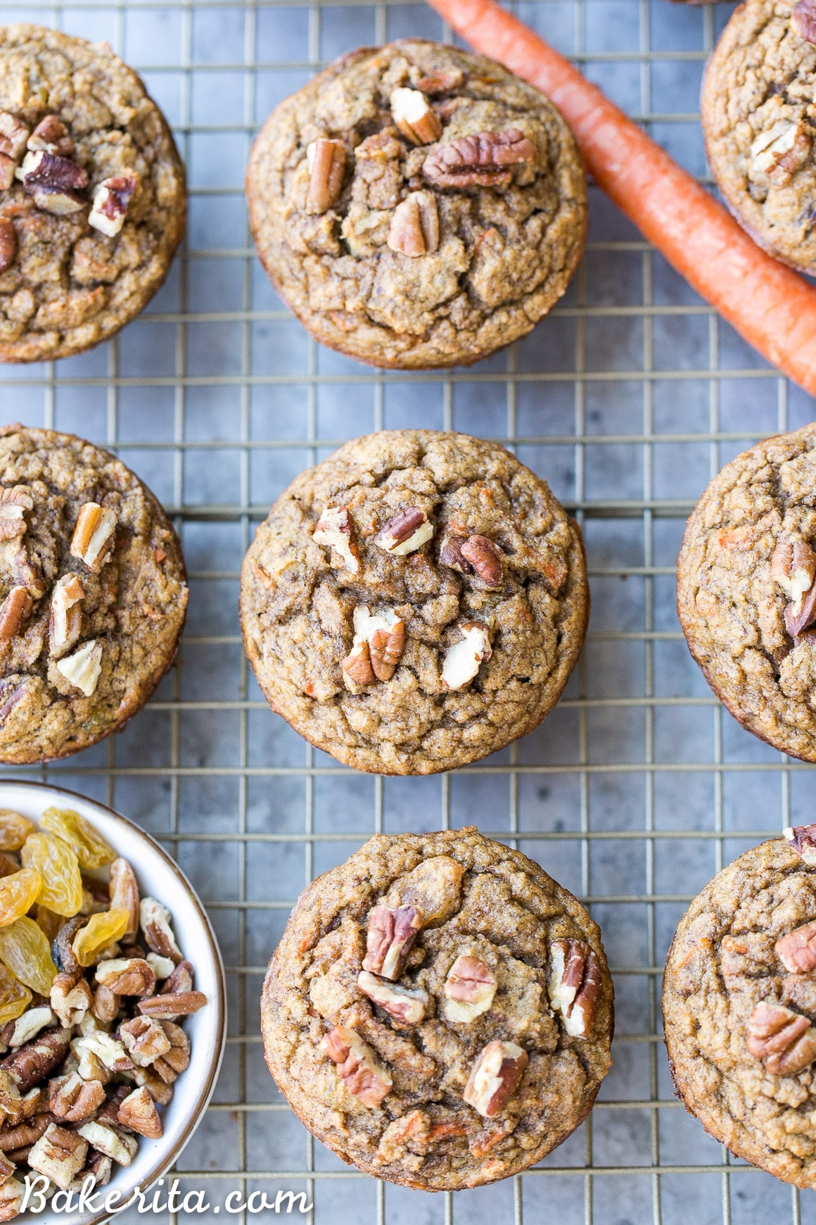These Paleo Morning Glory Muffins are loaded with bananas, shredded carrots, toasted walnuts, and golden raisins. These easy muffins have NO added sugar - they're sweetened entirely with bananas! They're the perfect on-the-go breakfast or snack.