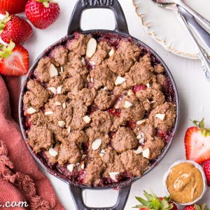 This Strawberry Crisp with Almond Butter Crumble is an irresistible pairing of fresh strawberries and a lightly-sweetened, rich and crispy almond butter cookie crumble. You won't be able to resist this gluten-free, paleo, and vegan dessert.