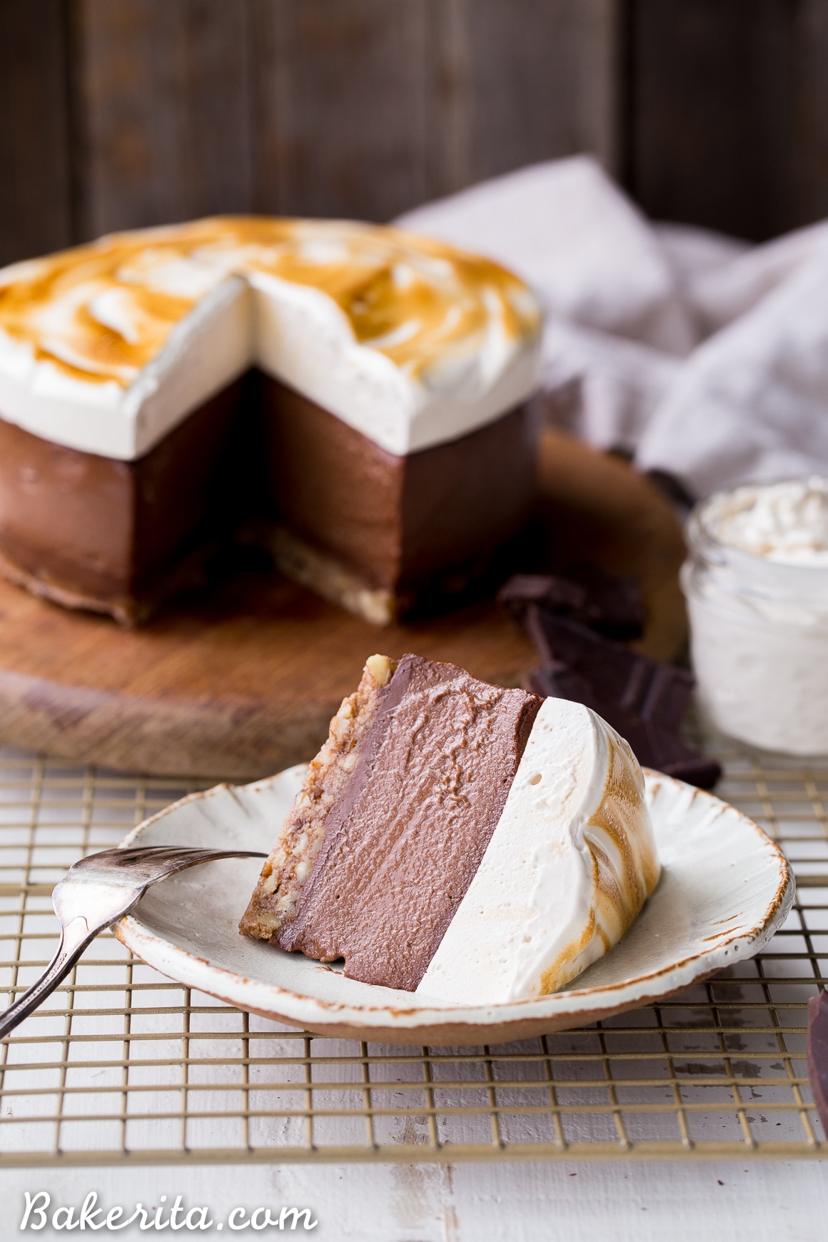This No Bake S'mores Cheesecake has a graham cracker flavored crust topped with chocolate ganache, rich chocolate "cheesecake" made with soaked cashews, and a layer of homemade toasted marshmallow on top! You'd never guess this decadent dessert is gluten-free, dairy-free, and Paleo.