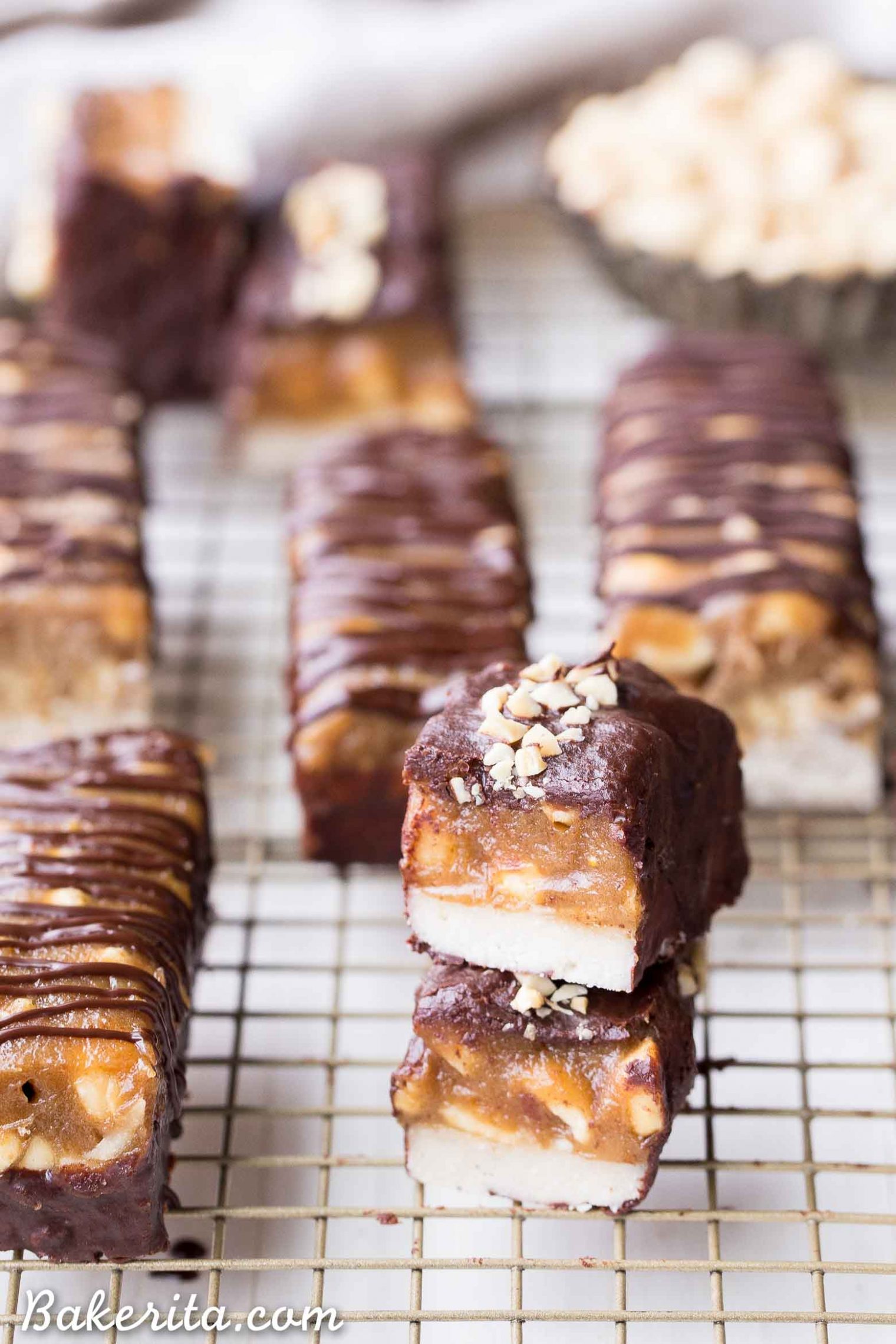 These Homemade Snickers Bars are a healthier version of the classic candy with no baking required! These gluten-free and vegan candy bars have a layer of raw nougat, topped with a peanut date caramel, all dunked in homemade chocolate.