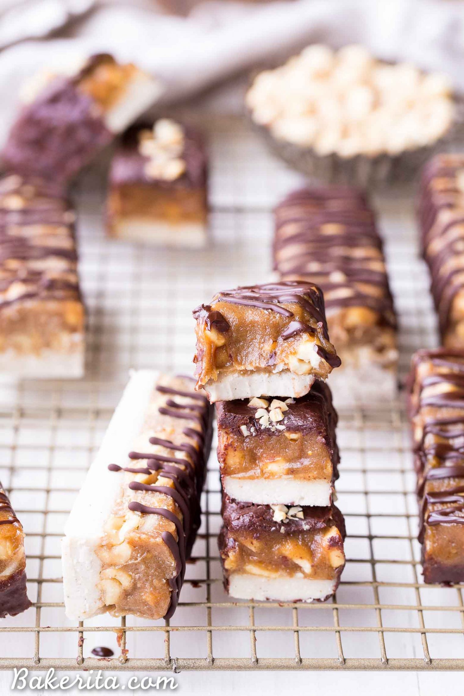 These Homemade Snickers Bars are a healthier version of the classic candy with no baking required! These gluten-free and vegan candy bars have a layer of raw nougat, topped with a peanut date caramel, all dunked in homemade chocolate.