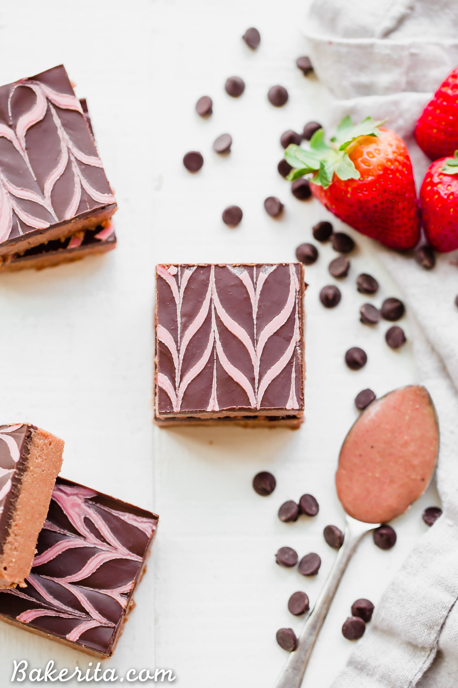 These No Bake Chocolate Strawberry Cashew Butter Bars have a creamy strawberry cashew butter base, topped with dark chocolate and a strawberry drizzle. You only need seven ingredients to make these irresistible gluten-free, paleo and vegan cashew butter bars.