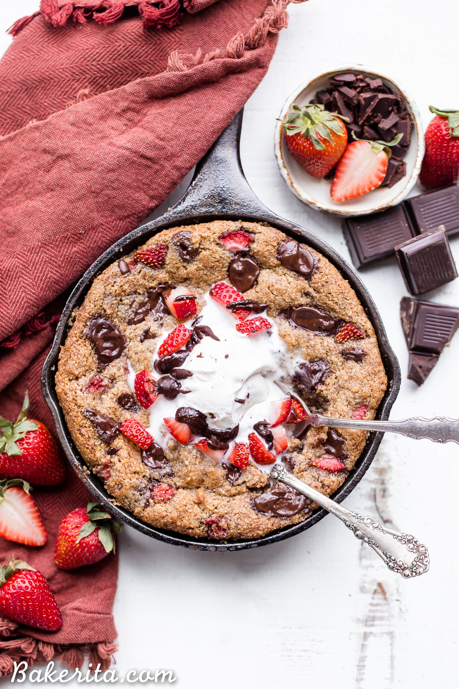 This Strawberry Chocolate Chunk Skillet Cookie is gooey in the middle, with crispy edges and all the flavors you love in a chocolate covered strawberry! This gluten-free, paleo and vegan skillet cookie will satisfy all your cravings - the fresh strawberries are the perfect fruity addition to this rich, chocolatey treat!