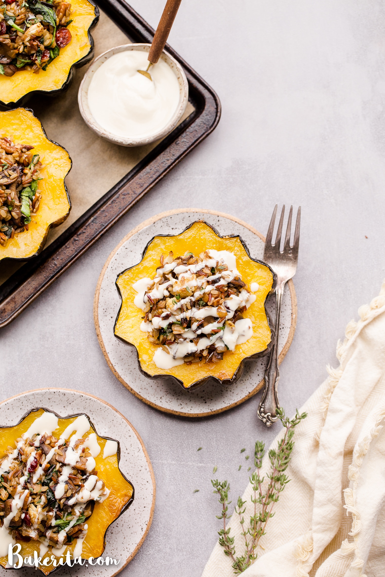 This Mushroom & Wild Rice Stuffed Acorn Squash is filled with caramelized onions, cauliflower florets, spinach, dried cranberries, and pecans. It's served with a drizzle of lemon tahini sauce. This comforting and colorful dish has a variety of texture, tons of flavor, and makes the perfect hearty dinner or side dish.