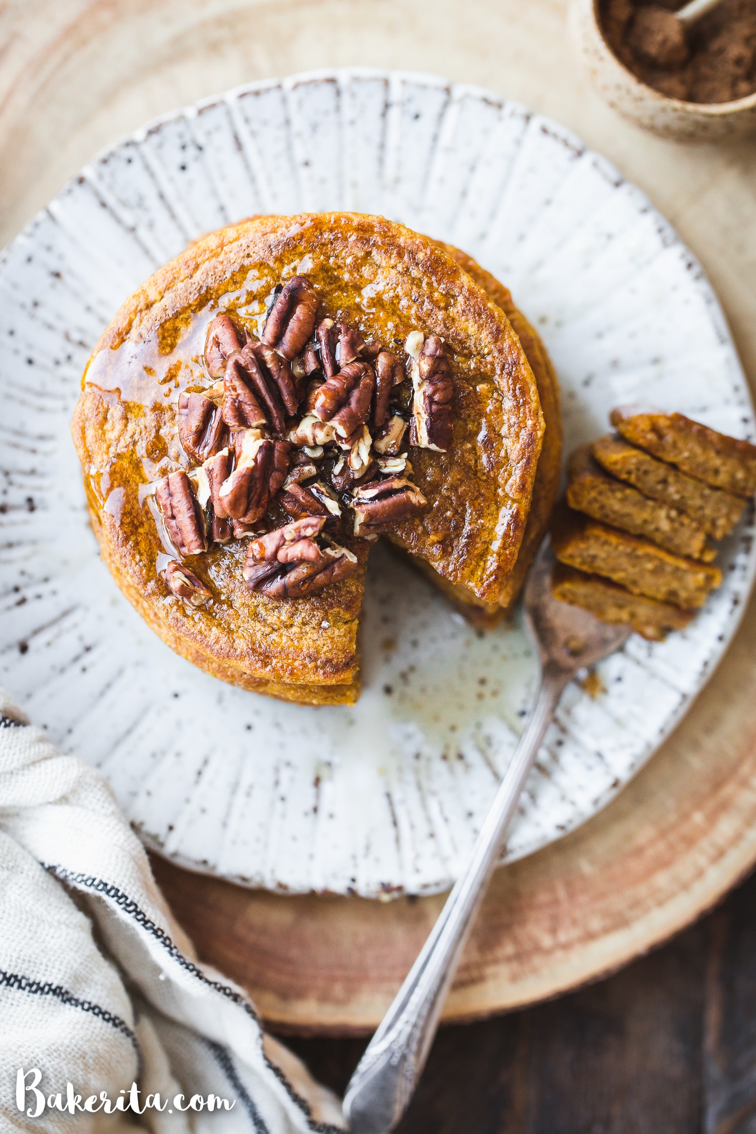 These Gluten-Free Vegan Pumpkin Pancakes tastes like fall thanks to the warm pumpkin spices and maple syrup! They're easy-to-make, light, fluffy, and absolutely delicious. 