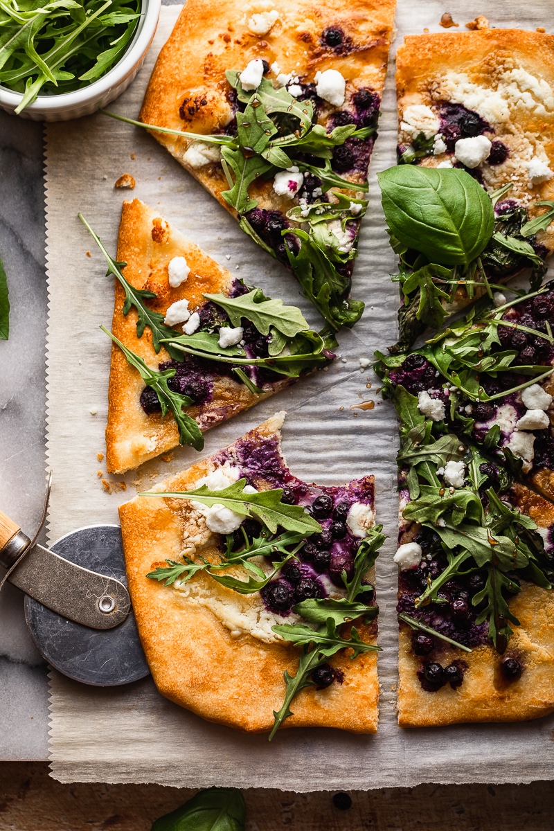 This gluten free pizza is loaded with wild blueberries, goat cheese and drizzled with balsamic reduction for just the right amount of sweet and tang! Blueberry balsamic goat cheese pizza is perfect for lunch or pizza night!
